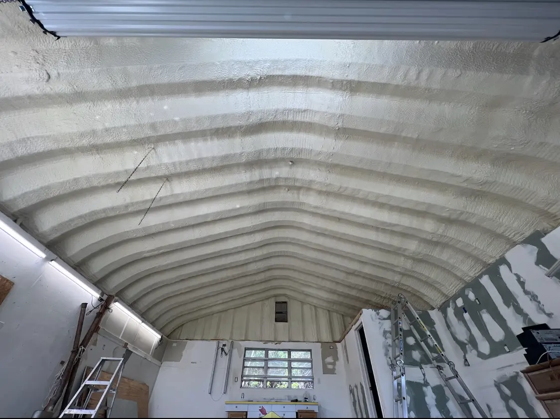 Spray polyurethane foam applied to the underside of a metal roof deck in Mission Bend